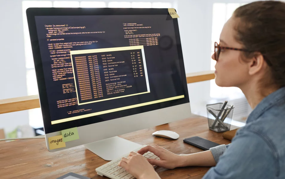 A woman developer writes code in the editor