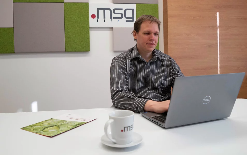 Java developer young man working on a laptop in the office of msg life Slovakia